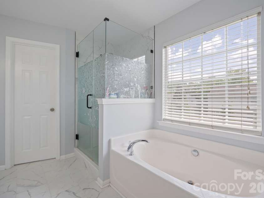 2237 Arbor Vista Drive, Charlotte, NC 28262.  MLS# CAR4395474, YatesRealty ID 32781. Primary bath with garden tub and separate glass shower