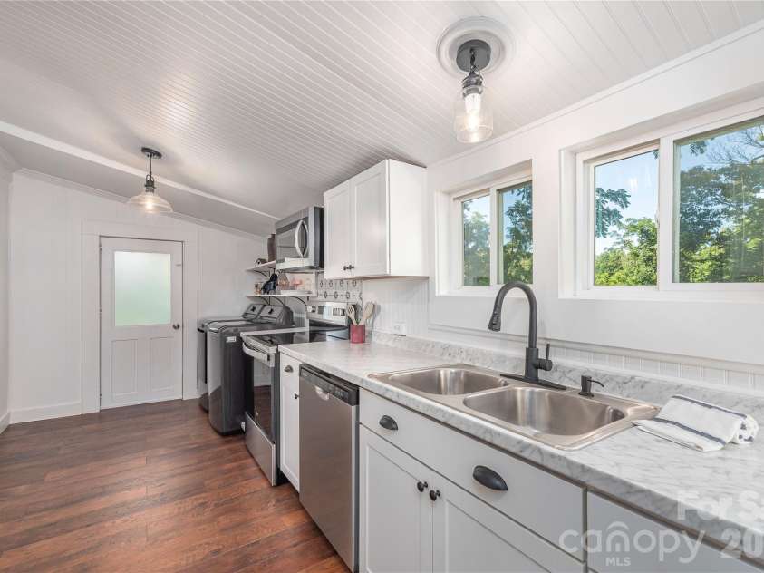 261 Star Ridge Road, Canton, NC 28716.  MLS# CAR4396365, YatesRealty ID 32791. Kitchen features generous counter space, updated cabinetry, and backyard views.