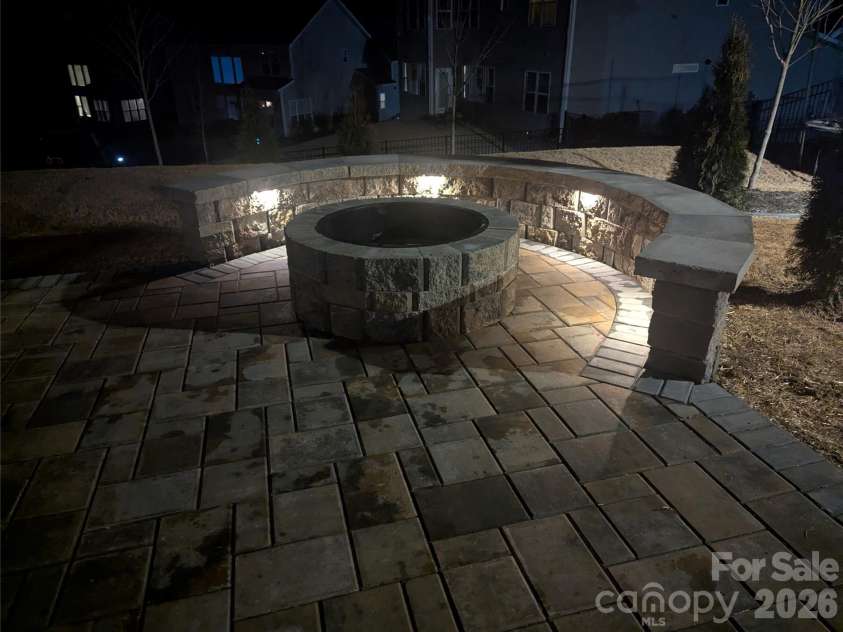 7004 Kingfisher Way, Belmont, NC 28012.  MLS# CAR4353741, YatesRealty ID 3281. Firepit at night with built in lighting