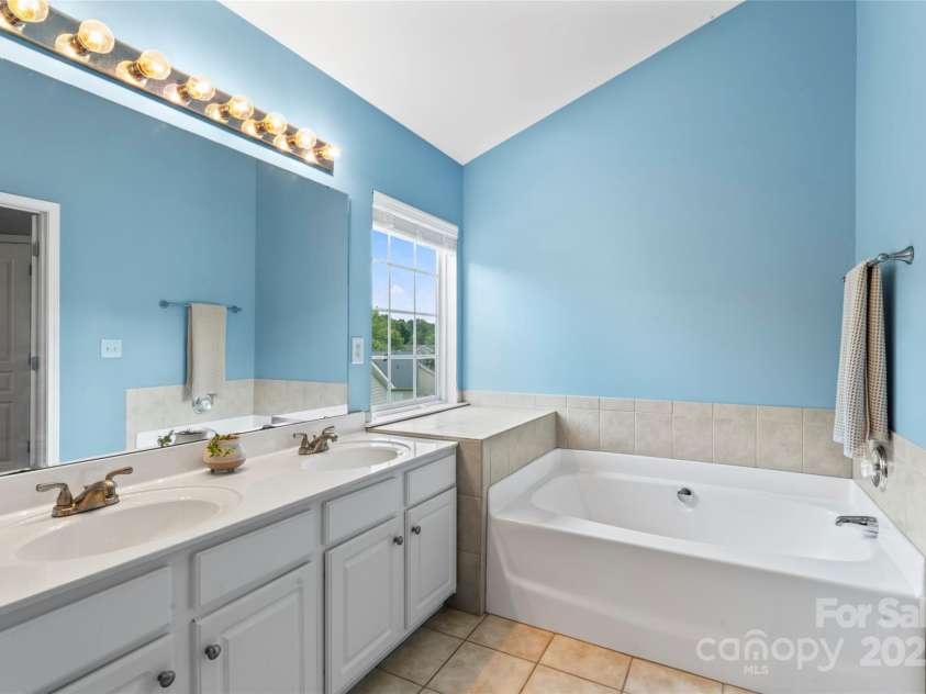 1046 Serel Drive, Stallings, NC 28104.  MLS# CAR4283202, YatesRealty ID 32816. Primary bath with dual vanities, garden tub, and stand alone shower