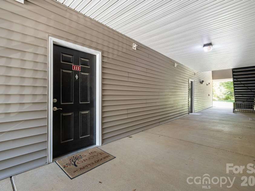 111 Appeldoorn Circle, Asheville, NC 28803.  MLS# CAR4397274, YatesRealty ID 32823. Condo front door and hallway to back common area