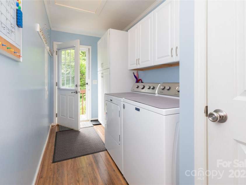 100 Susanna Cove Road, Mars Hill, NC 28754.  MLS# CAR4288018, YatesRealty ID 32835. Laundry area in hall with extra storage cabinets