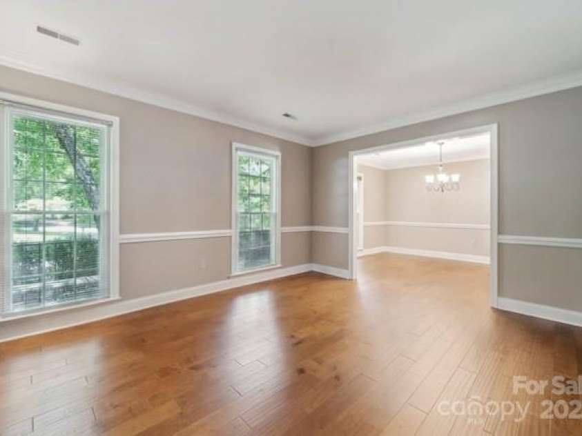 2234 Hamilton Mill Road, Charlotte, NC 28270.  MLS# CAR4261360, YatesRealty ID 32855. AI generated empty front room/dining room