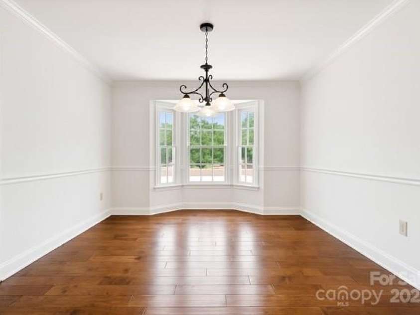 2234 Hamilton Mill Road, Charlotte, NC 28270.  MLS# CAR4261360, YatesRealty ID 32855. AI generated painted white eat in kitchen