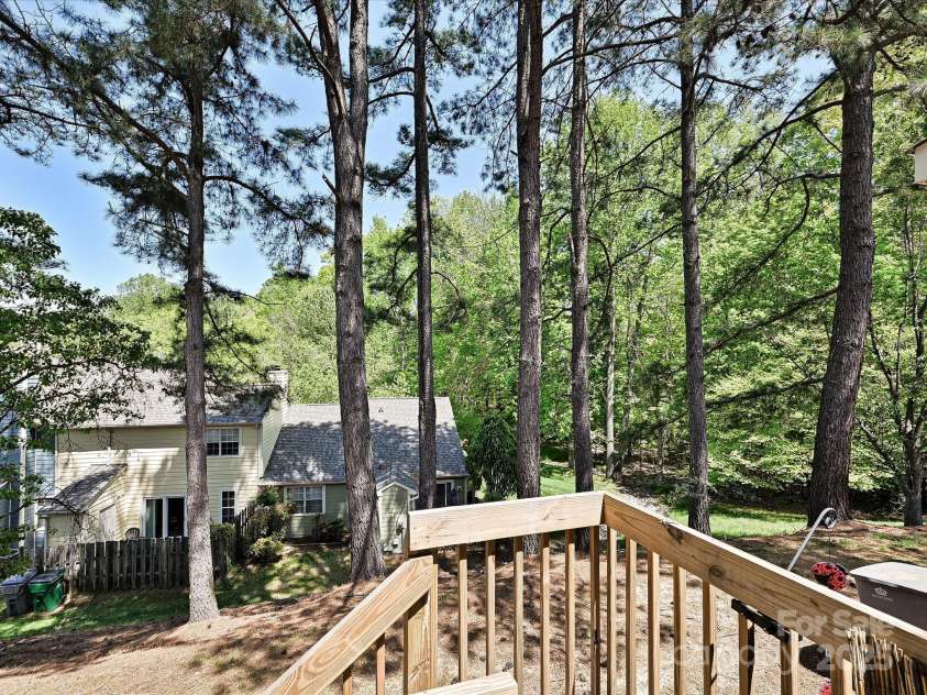 9305 Four Mile Creek Road, Charlotte, NC 28277.  MLS# CAR4244964, YatesRealty ID 32863. A wood deck in the trees