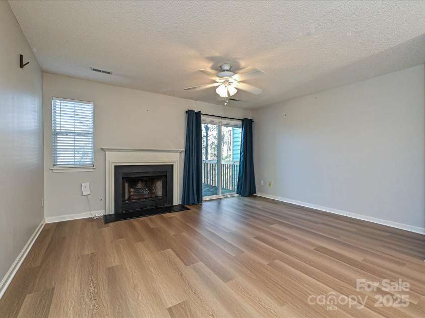 9305 Four Mile Creek Road, Charlotte, NC 28277.  MLS# CAR4332192, YatesRealty ID 32863. Living Room with Slider to exterior wood deck