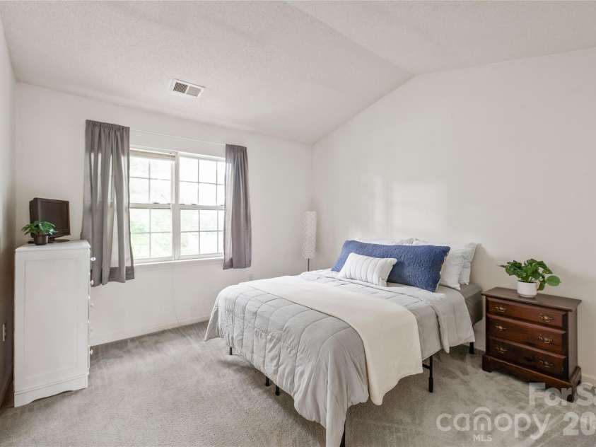 15411 Asterwind Court, Charlotte, NC 28277.  MLS# CAR4390329, YatesRealty ID 32878. Bedroom 2 with vaulted ceilings, its own full bathroom and walk-in closet.