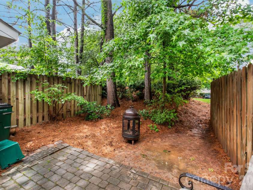 15411 Asterwind Court, Charlotte, NC 28277.  MLS# CAR4390329, YatesRealty ID 32878. Enjoy a rare wooded back patio that provides privacy, shade, and a serene outdoor space perfect for relaxing or entertaining.