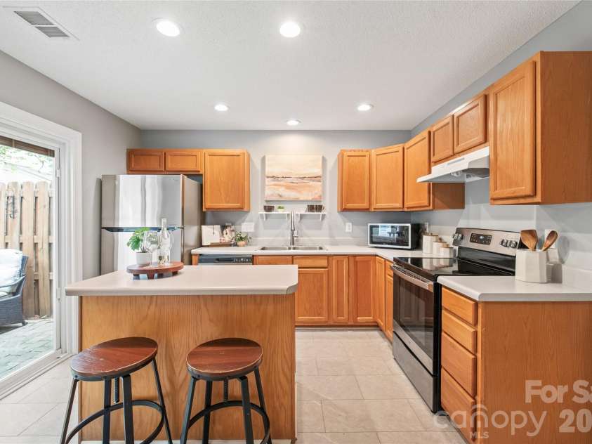 15411 Asterwind Court, Charlotte, NC 28277.  MLS# CAR4390329, YatesRealty ID 32878. Fresh, beautifully updated flooring sets the perfect stage for cooking and entertaining around the central kitchen island.