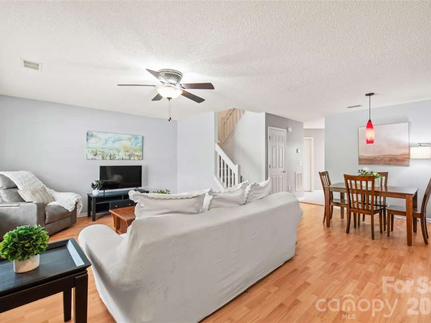 15411 Asterwind Court, Charlotte, NC 28277.  MLS# CAR4390329, YatesRealty ID 32878. Open living and dining area filled with natural light, offering a seamless layout perfect for everyday living and entertaining.