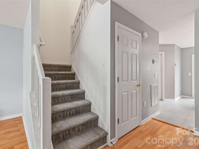 15411 Asterwind Court, Charlotte, NC 28277.  MLS# CAR4390329, YatesRealty ID 32878. Stairwell up to the bedrooms 