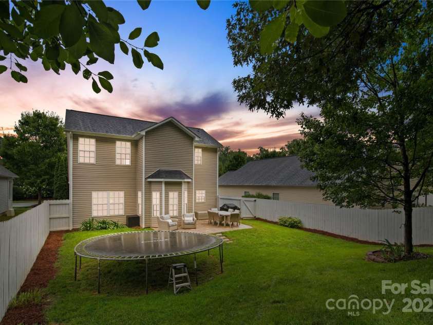 19333 Pocono Lane, Cornelius, NC 28031.  MLS# CAR4286537, YatesRealty ID 32878. An evening in the fully fenced backyard with the large paver patio.
