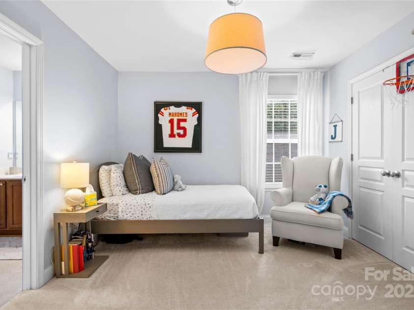 19333 Pocono Lane, Cornelius, NC 28031.  MLS# CAR4286537, YatesRealty ID 32878. Bedroom 3 with lovely updated designer light and closet built-in's