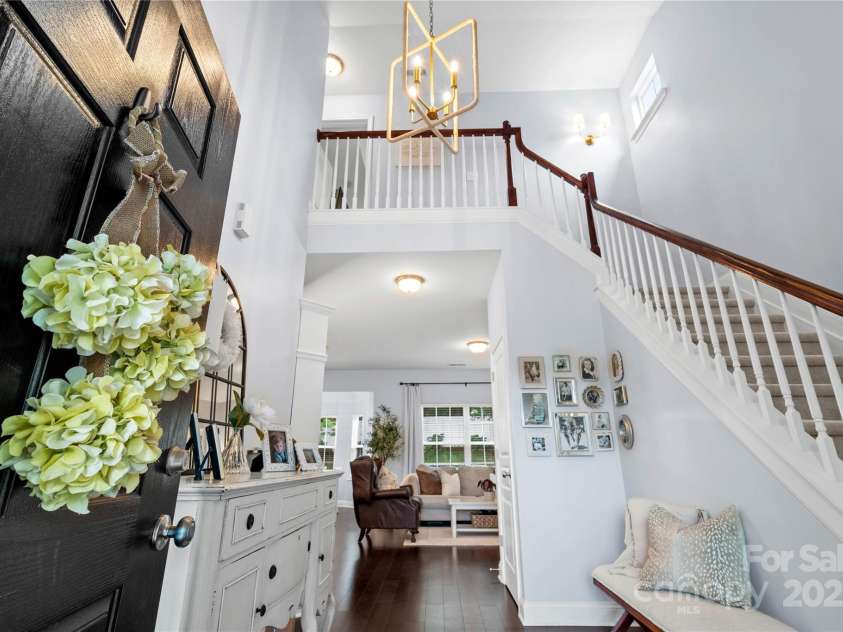 19333 Pocono Lane, Cornelius, NC 28031.  MLS# CAR4286537, YatesRealty ID 32878. Grand foyer with designer lighting and updated gold sconce going up the stairs.
