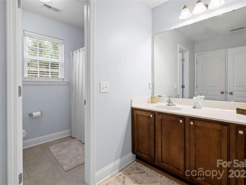 19333 Pocono Lane, Cornelius, NC 28031.  MLS# CAR4286537, YatesRealty ID 32878. Jack -n- Jill Bathroom. Large sink are, new cabinet hardware & you can close off the toilet and tub area for privacy.