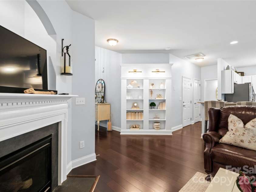 19333 Pocono Lane, Cornelius, NC 28031.  MLS# CAR4286537, YatesRealty ID 32878. View from Living Room looking at built in's and kitchen. The 2 doors are for the garage and pantry. Beautiful hardwood floors that are throughout the main floor!