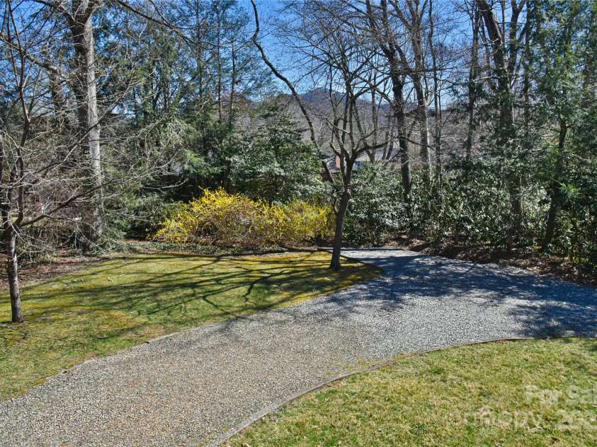 302 Montreat Road, Black Mountain, NC 28711.  MLS# CAR4234971, YatesRealty ID 3288. Large Level Backyard has Extra Parking and Turn-around