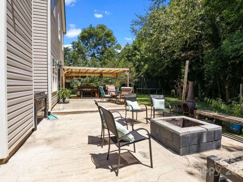 4205 Springhaven Drive, Charlotte, NC 28269.  MLS# CAR4275693, YatesRealty ID 32889. Fire pit with custom bench provides plenty of seating to gather around a warm fire.