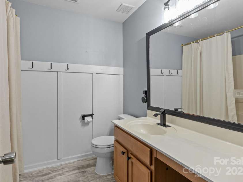 4205 Springhaven Drive, Charlotte, NC 28269.  MLS# CAR4275693, YatesRealty ID 32889. Hall bath with updated fixtures has new LVP flooring.