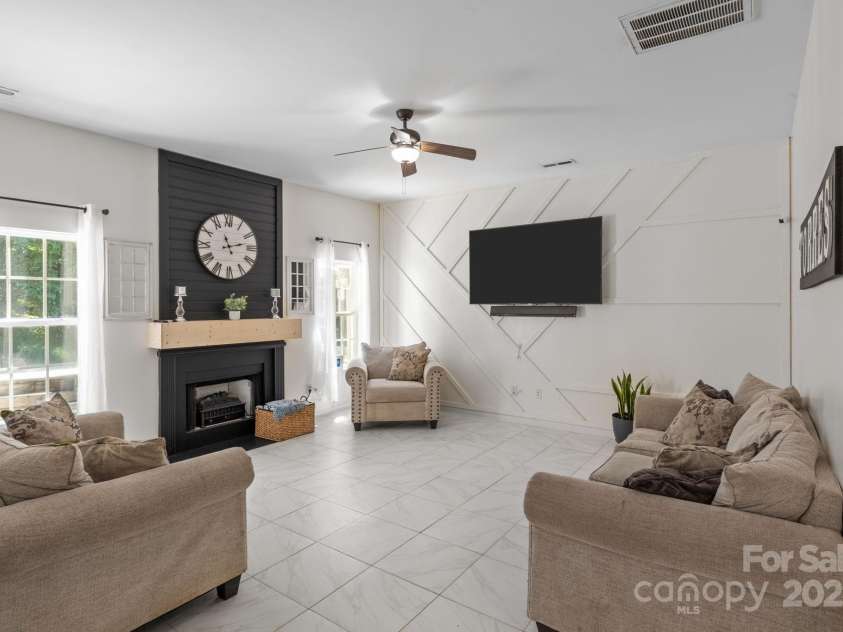 4205 Springhaven Drive, Charlotte, NC 28269.  MLS# CAR4275693, YatesRealty ID 32889. HUGE step down family room has tile flooring and beautifully updated fireplace.