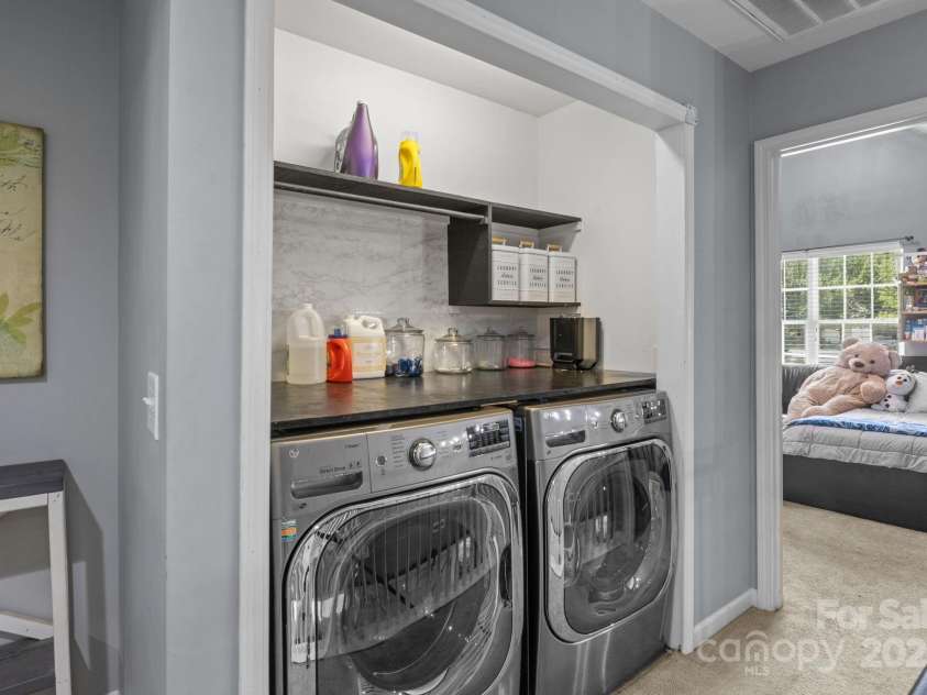 4205 Springhaven Drive, Charlotte, NC 28269.  MLS# CAR4275693, YatesRealty ID 32889. Laundry area offers custom shelves and countertop for your laundry needs.