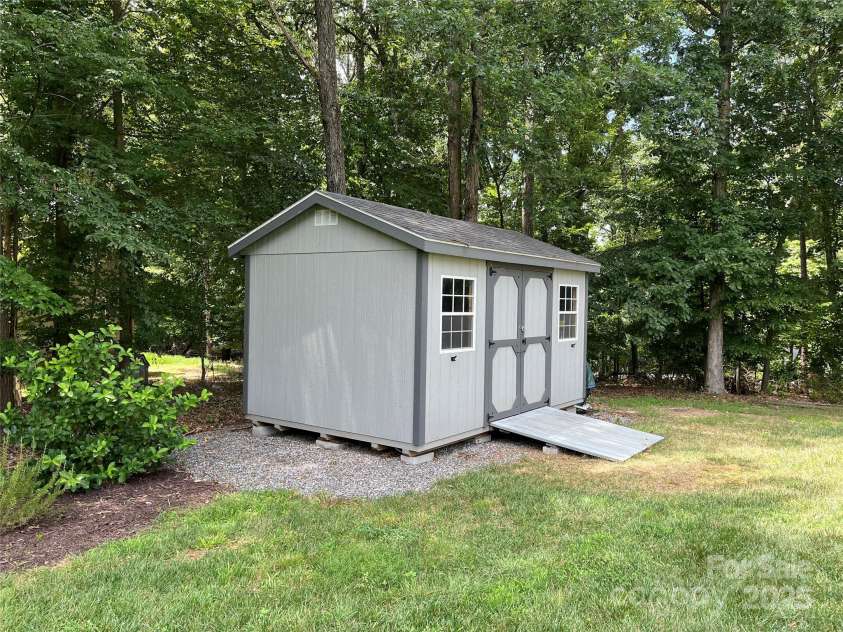 126 Redbud Lane, Troutman, NC 28166.  MLS# CAR4284135, YatesRealty ID 32890. In the backyard you will find this 10' x 16' shed to house all your lawn equipment.