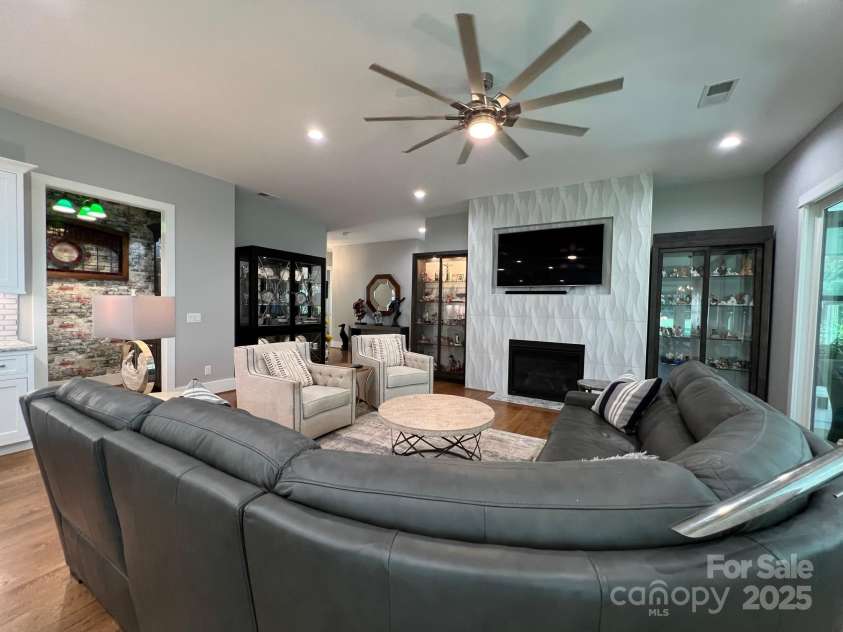 126 Redbud Lane, Troutman, NC 28166.  MLS# CAR4284135, YatesRealty ID 32890. The great room has a gas fireplace on a lovely tiled feature wall. No not miss the large ceiling fan.
