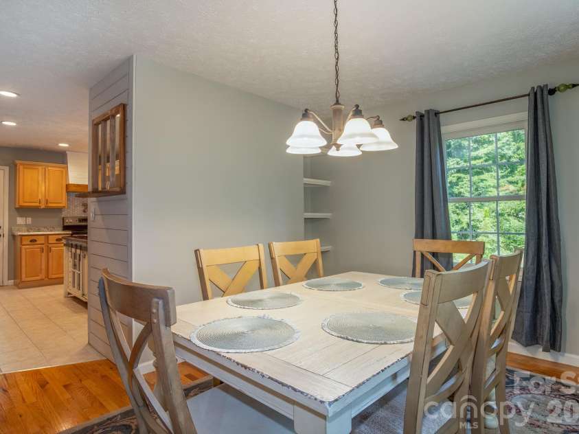 17 Squires Lane, Candler, NC 28715.  MLS# CAR4372745, YatesRealty ID 32899. Dining flows easily from the kitchen and living area for entertaining.