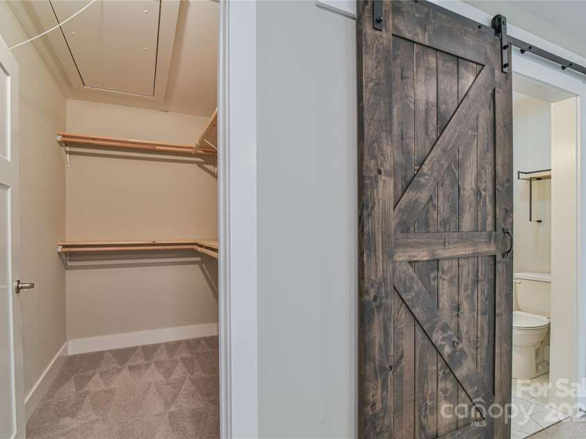 219 Fayetteville Street, Asheville, NC 28806.  MLS# CAR4291036, YatesRealty ID 32938. Primary suite, large walk-in closet and pull-down attic access.