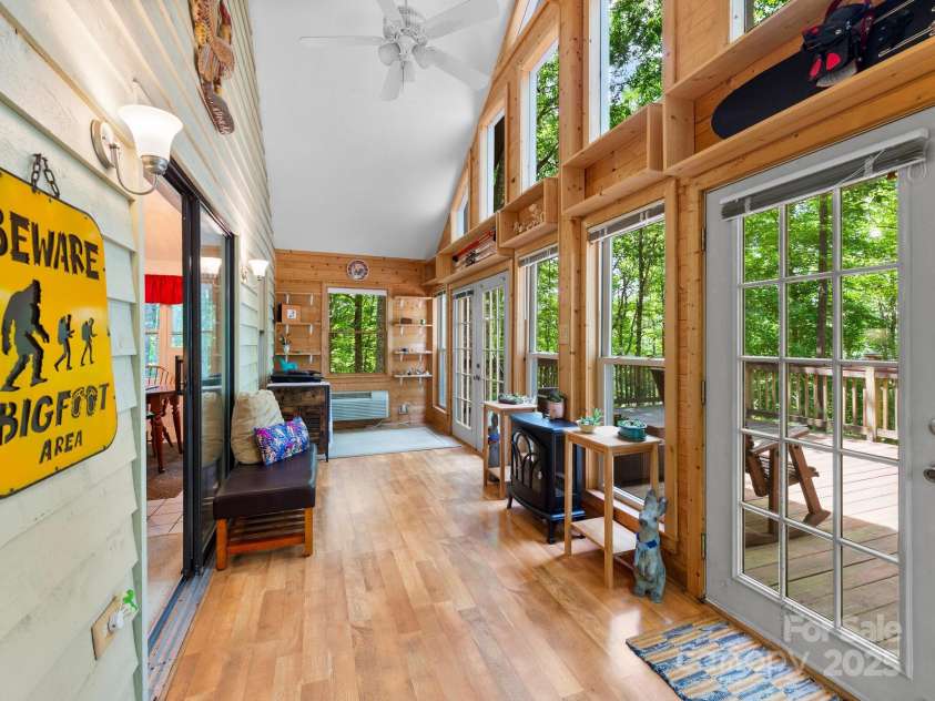 2838 Little Creek Road, Hendersonville, NC 28792.  MLS# CAR4282248, YatesRealty ID 32945. 4 season room to unwind and gaze out the floor to ceiling windows.