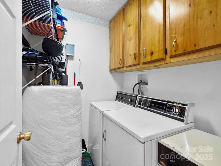 2838 Little Creek Road, Hendersonville, NC 28792.  MLS# CAR4282248, YatesRealty ID 32945. Main level laundry room with storage