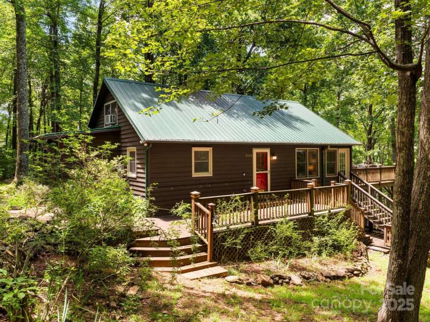 2838 Little Creek Road, Hendersonville, NC 28792.  MLS# CAR4282248, YatesRealty ID 32945. Nestled among the trees, this charming mountain cabin offers a secluded retreat from the hustle.