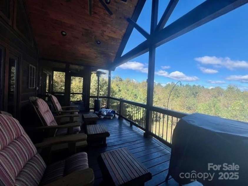 80 Grandview Loop, Nebo, NC 28761.  MLS# CAR4317495, YatesRealty ID 3296. Deck with forest and Blue Ridge Mountain vies.