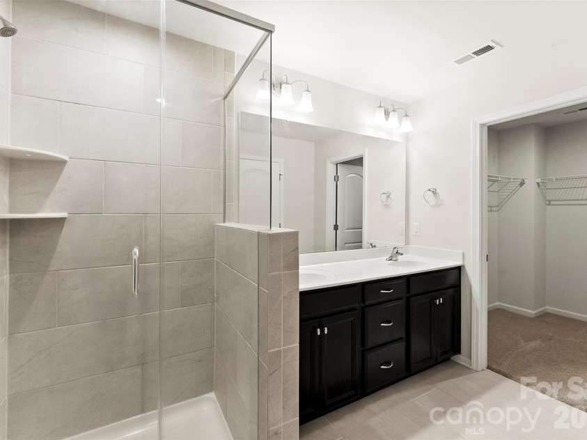 11010 Chalkbark Lane, Charlotte, NC 28262.  MLS# CAR4378415, YatesRealty ID 32962. Walk-in shower/ double vanity
