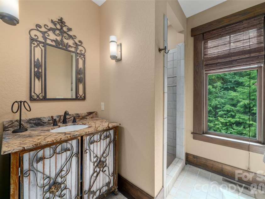257 Bear Landing Drive, Hendersonville, NC 28792.  MLS# CAR4388350, YatesRealty ID 32963. Cottage has a full bath on main level and a half bath on the lower level.