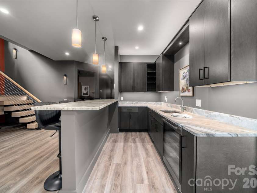 257 Bear Landing Drive, Hendersonville, NC 28792.  MLS# CAR4388350, YatesRealty ID 32963. Custom bar with leathered granite and beverage refrigerator.