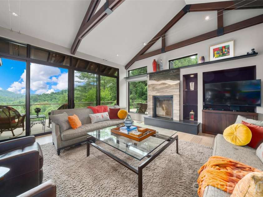 257 Bear Landing Drive, Hendersonville, NC 28792.  MLS# CAR4388350, YatesRealty ID 32963. Custom designed Renaissance fireplace with a retractable screen captures the mountain ridgeline.