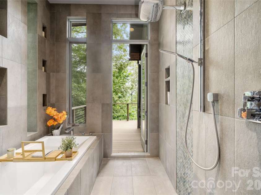 257 Bear Landing Drive, Hendersonville, NC 28792.  MLS# CAR4388350, YatesRealty ID 32963. Designed to blur the line between indoors and out, direct deck access creates a luxurious, spa-like experience reminiscent of a private outdoor shower.