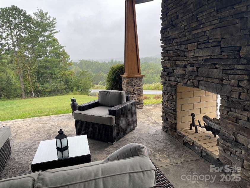 700 Bear Cliff Drive, Nebo, NC 28761.  MLS# CAR4304808, YatesRealty ID 3298. Lanai - Double sided wood burning fireplace