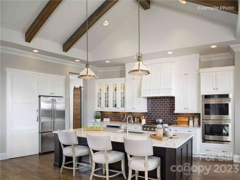 129 Sleepy Cove Trail, Mooresville, NC 28117.  MLS# CAR3936807, YatesRealty ID 33. Chef's Kitchen with Monogram Appliances and Cabinet Concealed Walk-In Pantry!