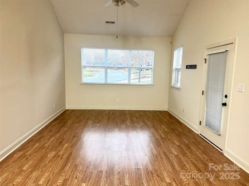 6295 Pansy Trail, Denver, NC 28037.  MLS# CAR4285349, YatesRealty ID 33010. Large living room with large windows and exit out to patio