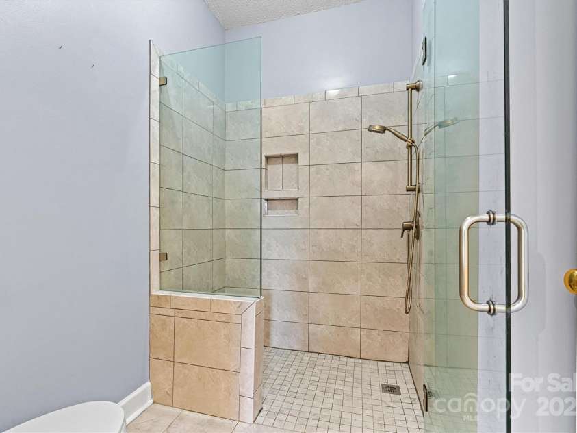 6295 Pansy Trail, Denver, NC 28037.  MLS# CAR4285349, YatesRealty ID 33010. Updated primary bathroom walk-in shower with bench