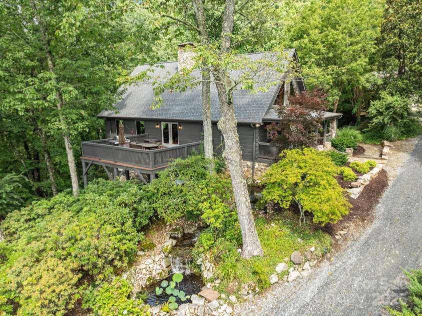 670 Barber Road, Zirconia, NC 28790.  MLS# CAR4293053, YatesRealty ID 33016. Lower level triple falls water feature