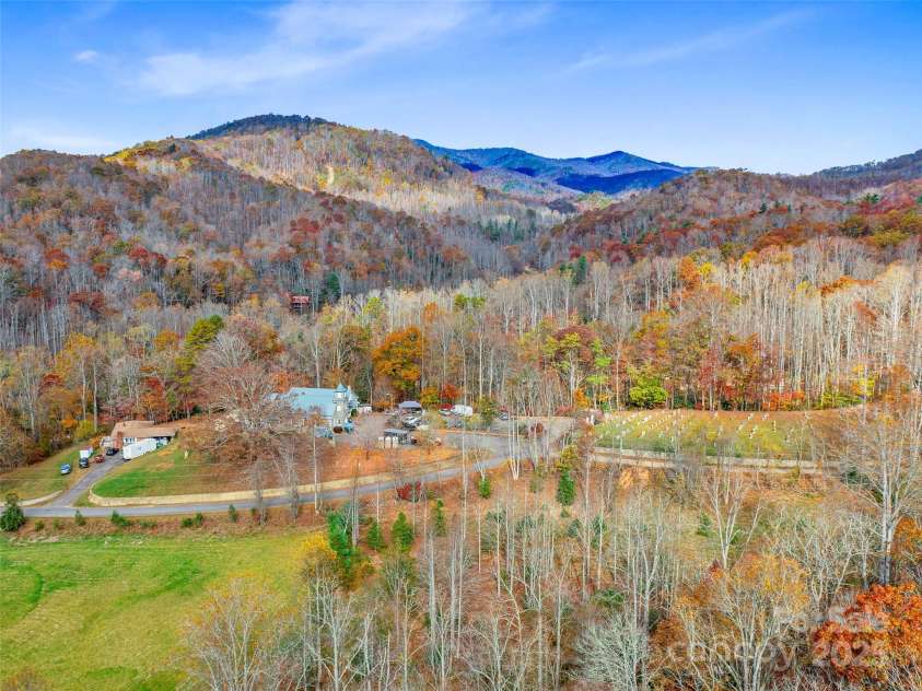 384 Flat Creek Road, Fairview, NC 28730.  MLS# CAR4240696, YatesRealty ID 3302. Drone view looking from ridge in the rear of property toward Nesbitt Chapel and church Parking lot. Nesbitt Chapel Road (paved) is in the foreground.