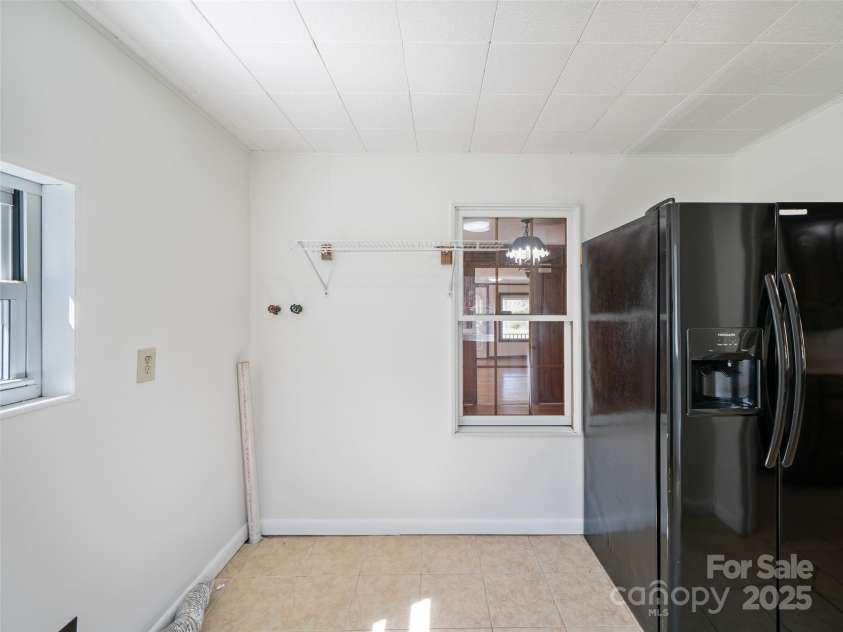 384 Flat Creek Road, Fairview, NC 28730.  MLS# CAR4240696, YatesRealty ID 3302. Laudry room with extra refrigerator.