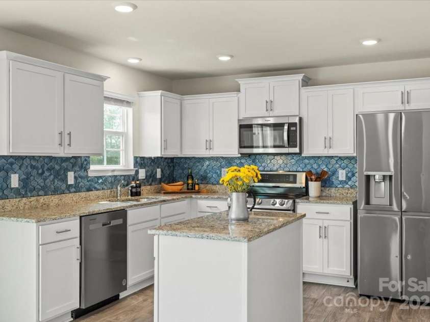 155 Rebecca Avenue, Lexington, NC 27295.  MLS# CAR4284229, YatesRealty ID 33023. Gorgeous kitchen with granite countertops, SS appliances, Island with storage, stunning backsplash and you need to see the VIEW from the sink!!!!