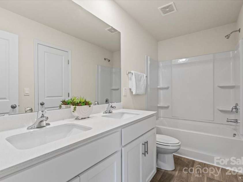 155 Rebecca Avenue, Lexington, NC 27295.  MLS# CAR4284229, YatesRealty ID 33023. The full bathroom upstairs with a double sink vanity