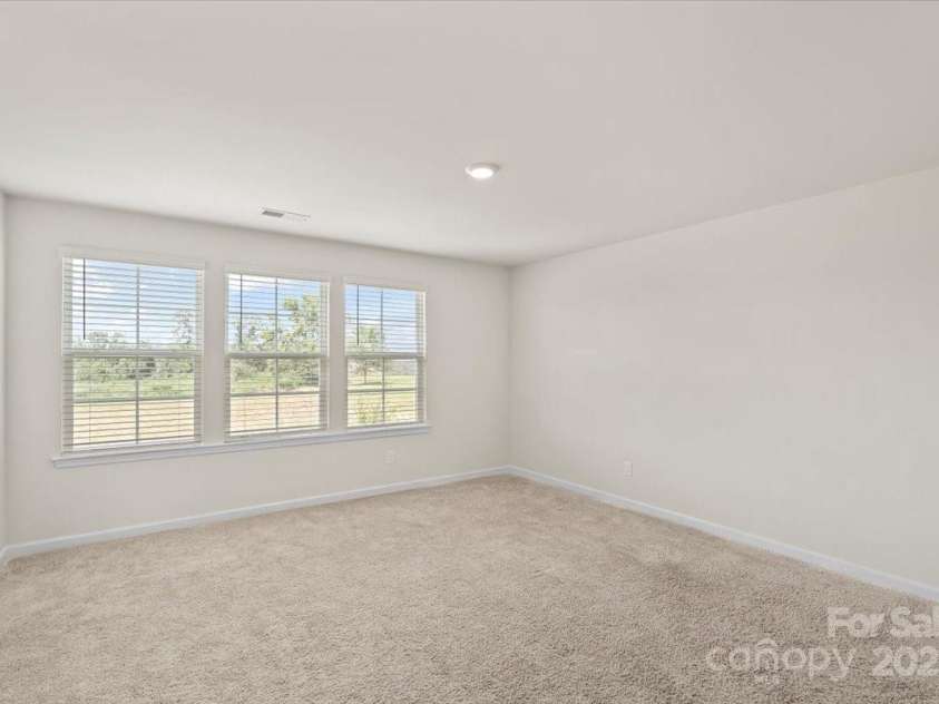 155 Rebecca Avenue, Lexington, NC 27295.  MLS# CAR4284229, YatesRealty ID 33023. Upstairs bedroom with triple windows overlooking the peaceful view out front