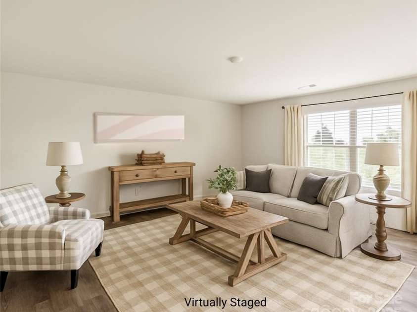 155 Rebecca Avenue, Lexington, NC 27295.  MLS# CAR4284229, YatesRealty ID 33023. Virtually staged large living room at the back of the home, with more private, beautiful views.