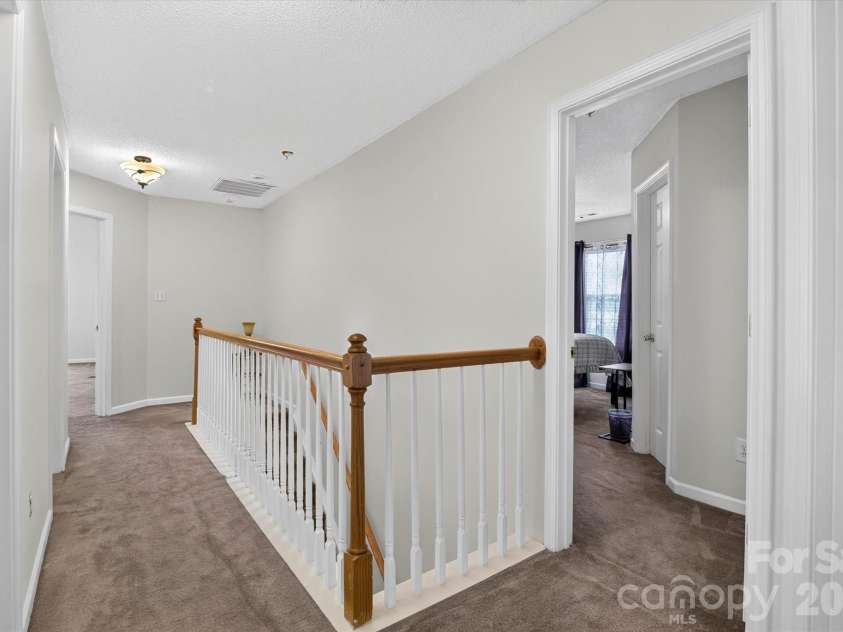 9833 Aventide Lane, Charlotte, NC 28215.  MLS# CAR4377310, YatesRealty ID 33061. 2nd Level Hallway leading to stairway